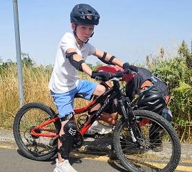 Child with bicycle and equipment